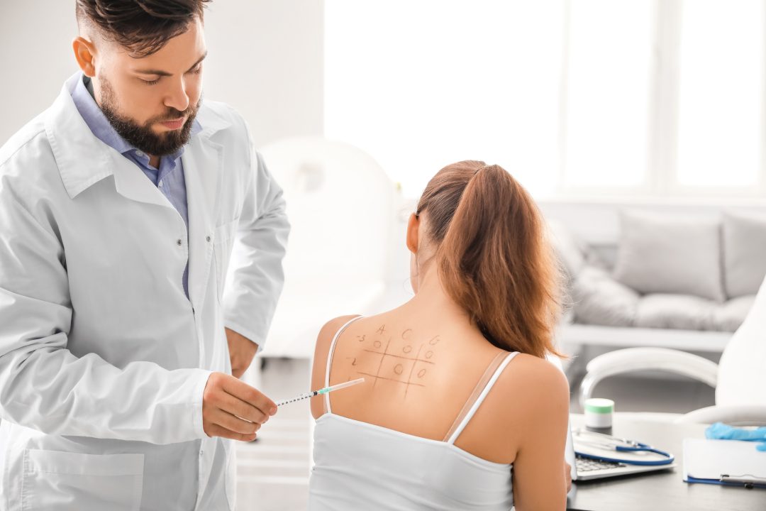 Young woman undergoing allergen skin test in clinic